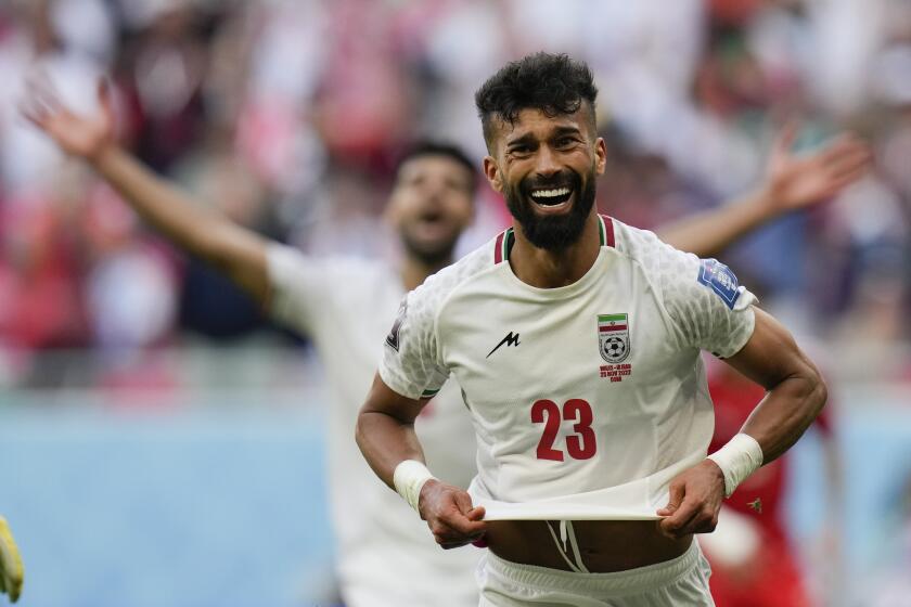 Iran's Ramin Rezaeian celebrates scoring his side's second goal against Wales 