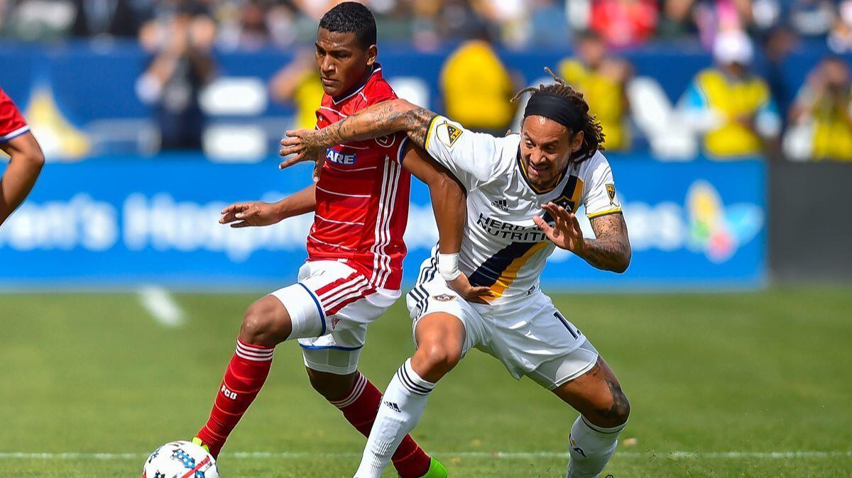 Galaxy midfielder Jermaine Jones, right, contends with FC Dallas midfielder Carlos Gruezo. Jones has been suspended by MLS for Sunday's game against Portland because of an infraction committed against Dallas on Saturday.