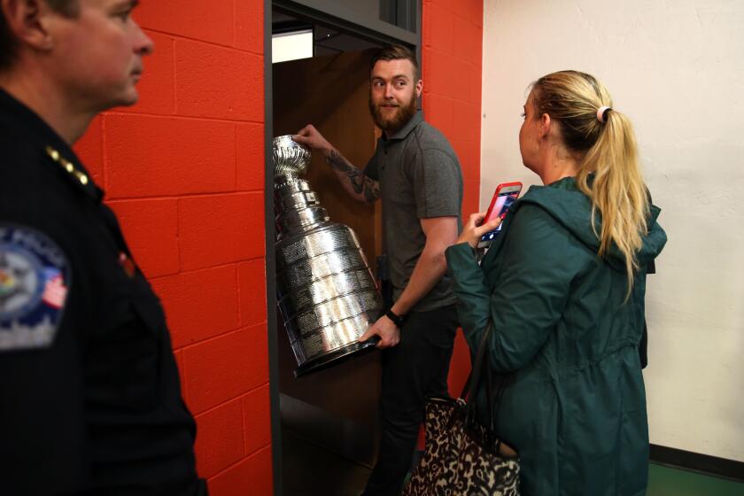 After signing hundreds of autographs for fans, Scott Darling leaves Centennial Park with the Stanley Cup.
