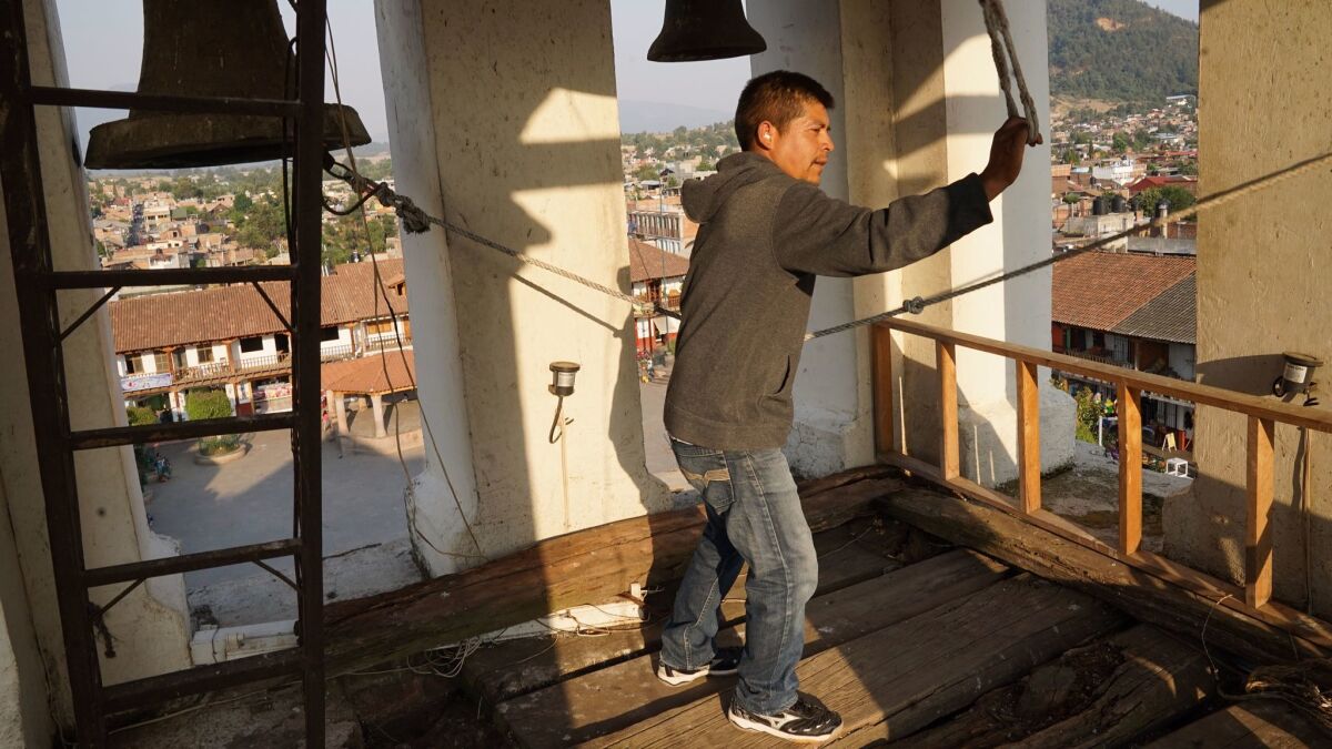 As at the beginning of the Cheran rebellion on April 15, 2011, a man rings church bells in a tower high above town. (Liliana Nieto del Rio / For The Times)