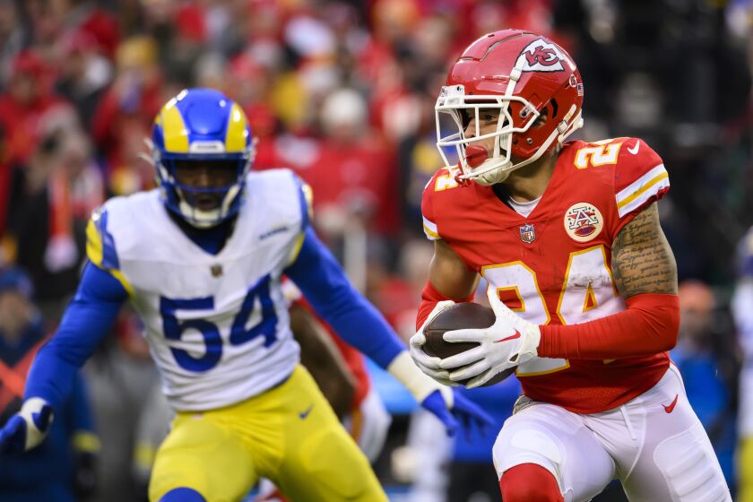 Kansas City Chiefs wide receiver Skyy Moore (24) makes a catch and run while being covered by Los Angeles Rams linebacker Leonard Floyd (54) during the first half of an NFL football game, Sunday, Nov. 27, 2022 in Kansas City, Mo. (AP Photo/Reed Hoffmann)