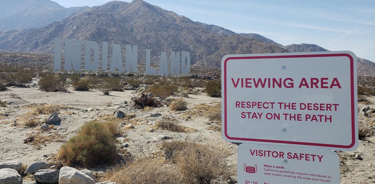 Tall white letters spell "Indianland" in the Palm Springs desert.