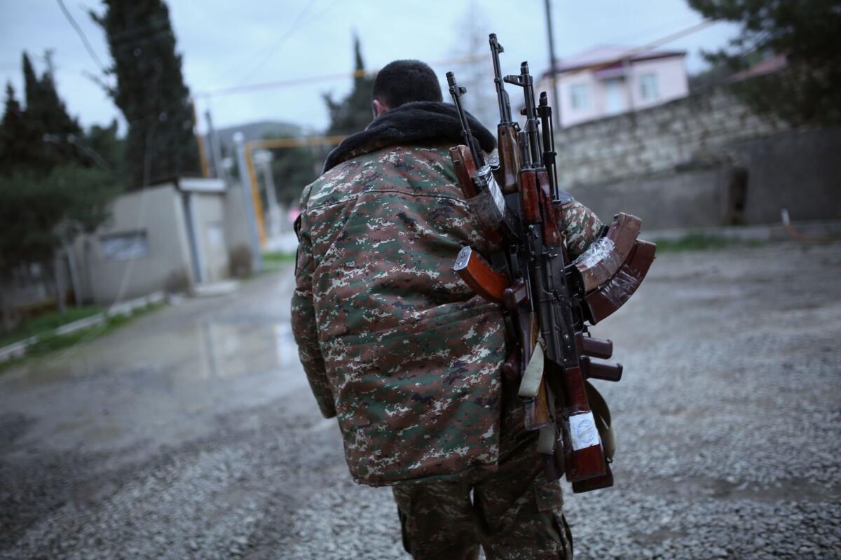 A soldier of Nagorno-Karabakh carries weapons in the Martakert region on April 4.