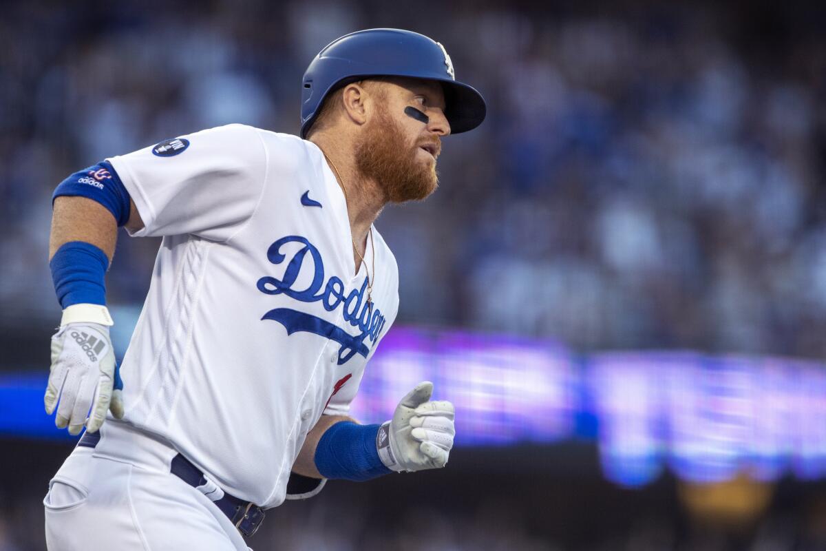 Justin Turner rounds the bases after hitting a three-run home run.