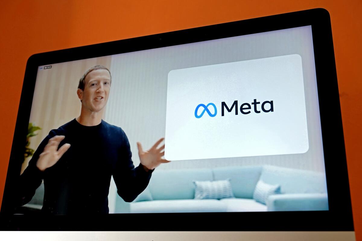 Meta Chief Executive Mark Zuckerberg is seen on the screen of a device next to the Meta logo.