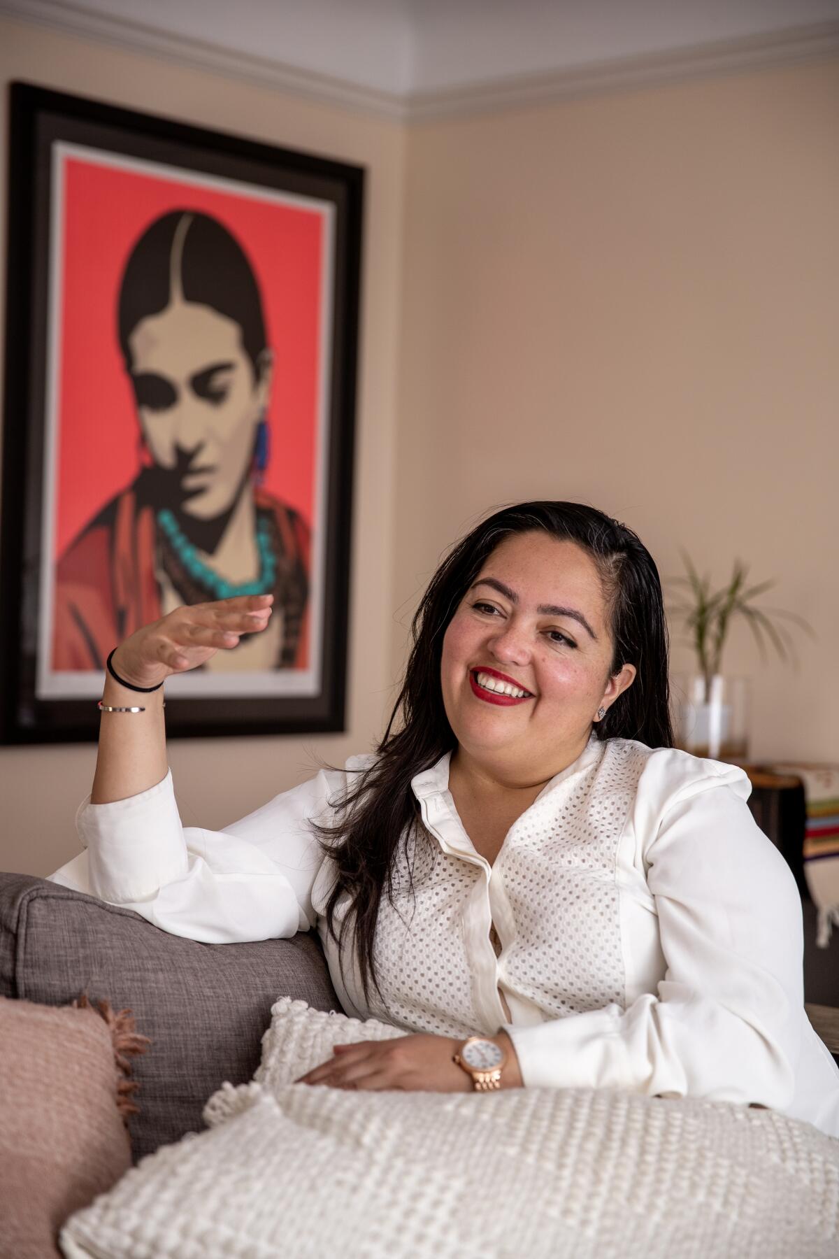 A vertical portrait frame of Wendy Carrillo, seated and gesturing while talking