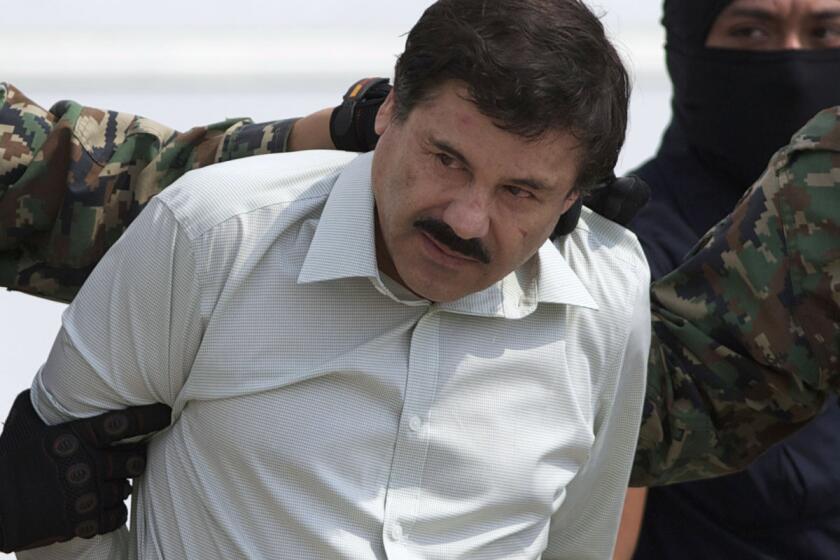 FILE - This Feb. 22, 2014 file photo shows Joaquin "El Chapo" Guzman, the head of Mexicoís Sinaloa Cartel, being escorted to a helicopter in Mexico City following his capture overnight in the beach resort town of Mazatlan. In federal court in Chicago on Friday, March 7, 2014, Alfredo Vasquez Hernandez, a reputed lieutenant of the recently captured drug lord, abruptly reversed his plans to plead guilty Friday to federal trafficking charges, a move made out of fear for the lives of his wife and children in Mexico, according to his attorney. (AP Photo/Eduardo Verdugo, File) ** Usable by LA and DC Only **