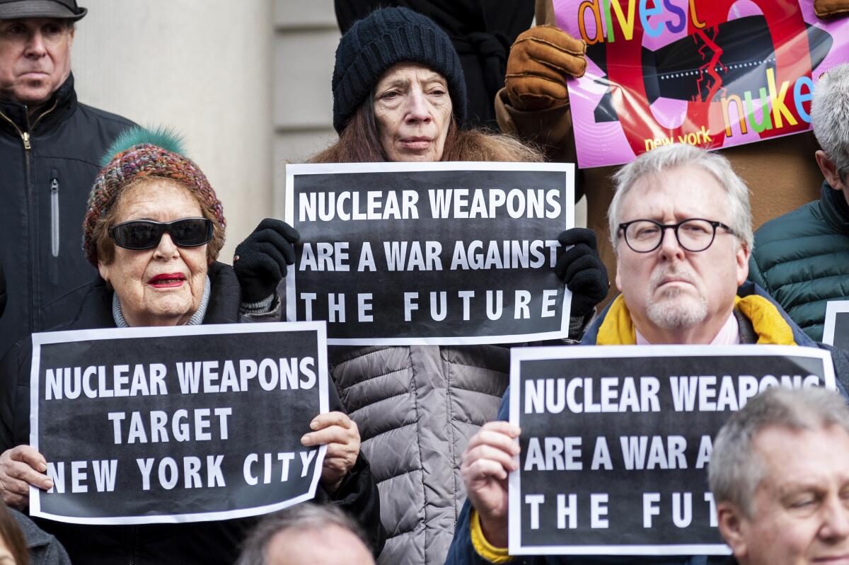 Activists rally at a press conference calling for the divestment from nuclear weapons.
