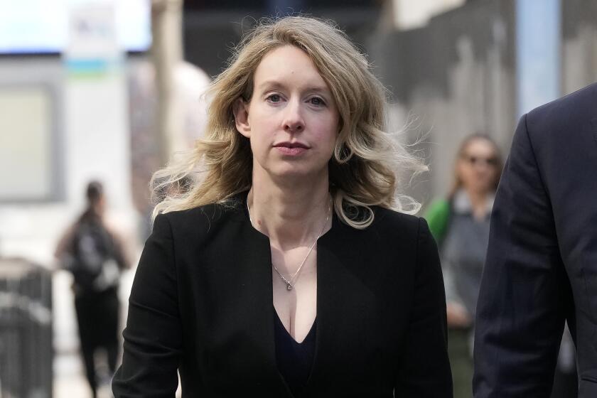 FILE - Former Theranos CEO Elizabeth Holmes leaves federal court in San Jose, Calif., March 17, 2023. Holmes has asked a federal judge, Wednesday, May 17, 2023, to allow her to remain free through the Memorial Day weekend before surrendering to authorities on May 30, to begin her more than 11-year prison sentence for defrauding investors in a blood-testing scam. (AP Photo/Jeff Chiu, File)