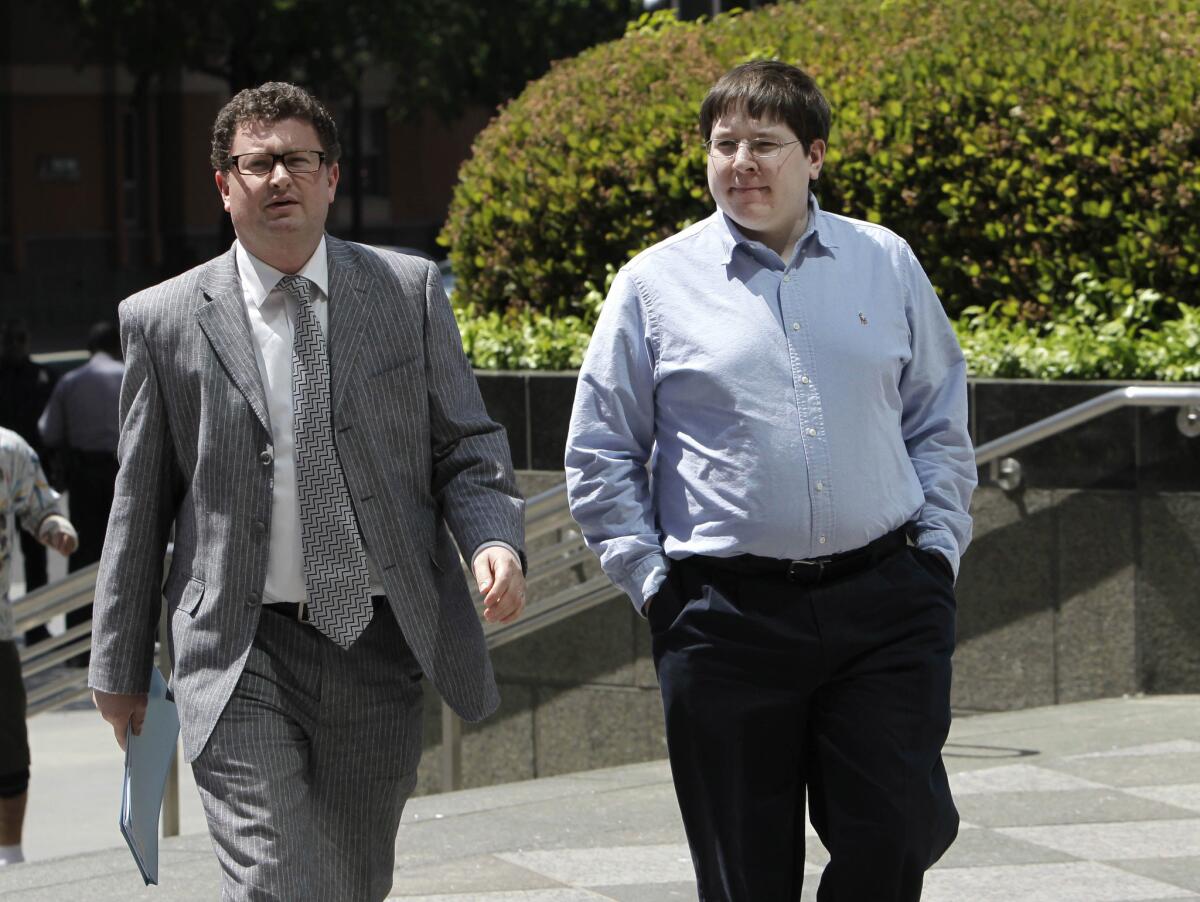 In this April 23, 2013, file photo, Matthew Keys, right, walks to the federal courthouse in Sacramento for his arraignment with his attorney Jason Leiderman.
