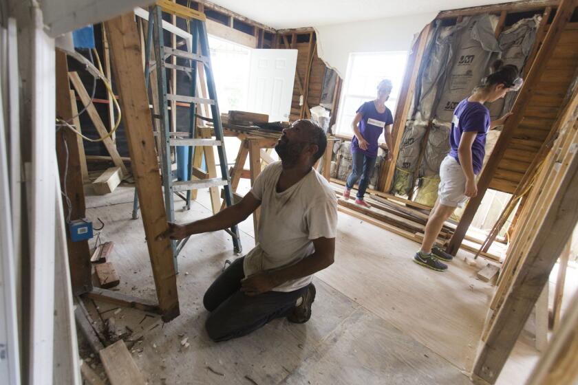 Volunteer coordinator Darren McKinney works on a hurricane-damaged home in the Lower 9h Ward of New Orleans. McKinney works for lowernine.org, an organization aiding residents rebuilding their homes.