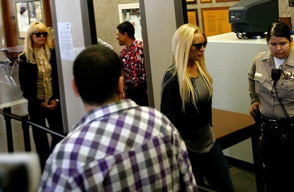 Dina Lohan, at left, accompanies daughter Lindsay at the Beverly Hills Courthouse as she surrenders for a jail sentence.