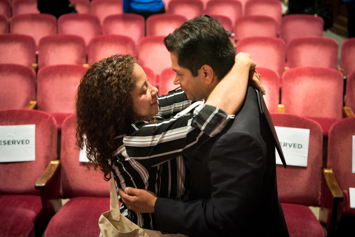 Jimmy Gomez gets a hug from his wife, Mary Hodge, before a 34th Congressional District debate.
