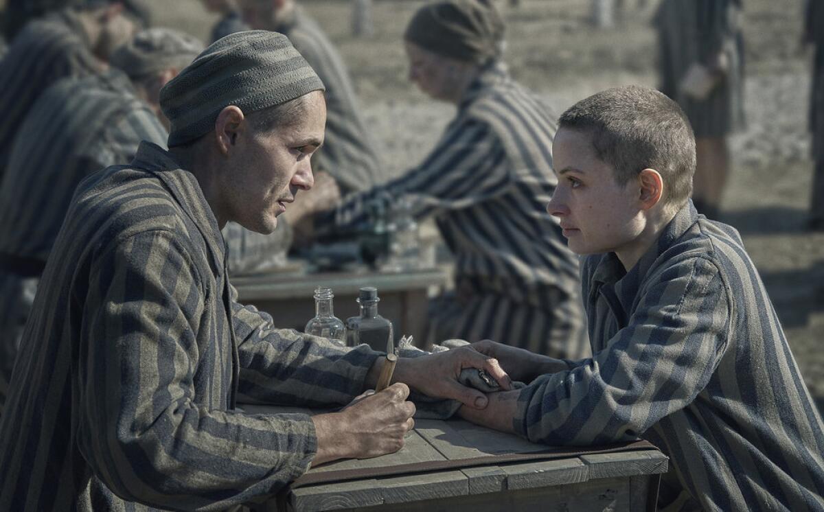 Jonah Hauer-King as young Lali, left, and Anna Próchniak as Gita in Peacock's "The Tattooist of Auschwitz."