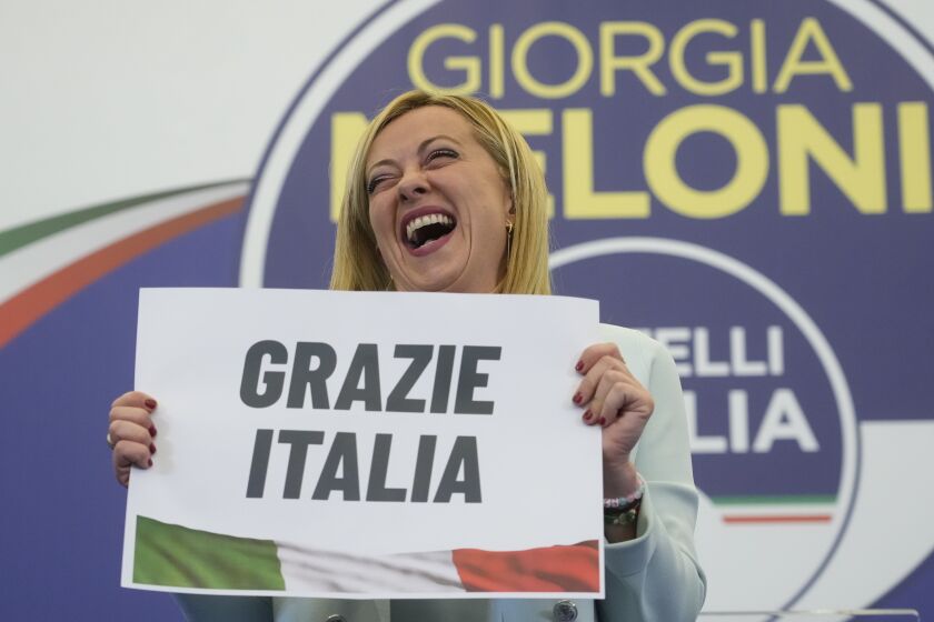 Far-Right party Brothers of Italy's leader Giorgia Meloni shows a placard reading in Italian "Thank you Italy" at her party's electoral headquarters in Rome, Sunday, Sept. 25, 2022. Italians voted in a national election that might yield the nation's first government led by the far right since the end of World War II. (AP Photo/Gregorio Borgia)