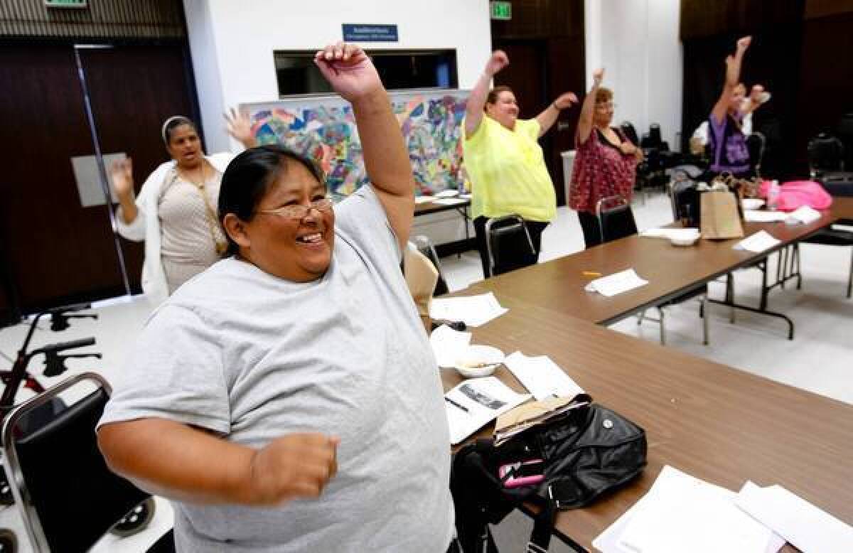 Cecilia Ceron does calisthenics with others during a group treatment session for obese patients at the Martin Luther King clinic in South Los Angeles.