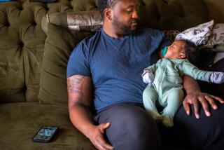 Compton, CA - June 15: Danny Rollins, 32, holds his newborn Braylen Rollins in their home on Thursday, June 15, 2023, in Compton, CA. A new study finds that fathers can make a huge difference in determining whether their baby is successfully breastfed and put to sleep safely. Danny Rollins in Compton is the enthusiastic father of a five-week-old baby boy. Rollins doing everything he can to be supportive. (Francine Orr / Los Angeles Times)