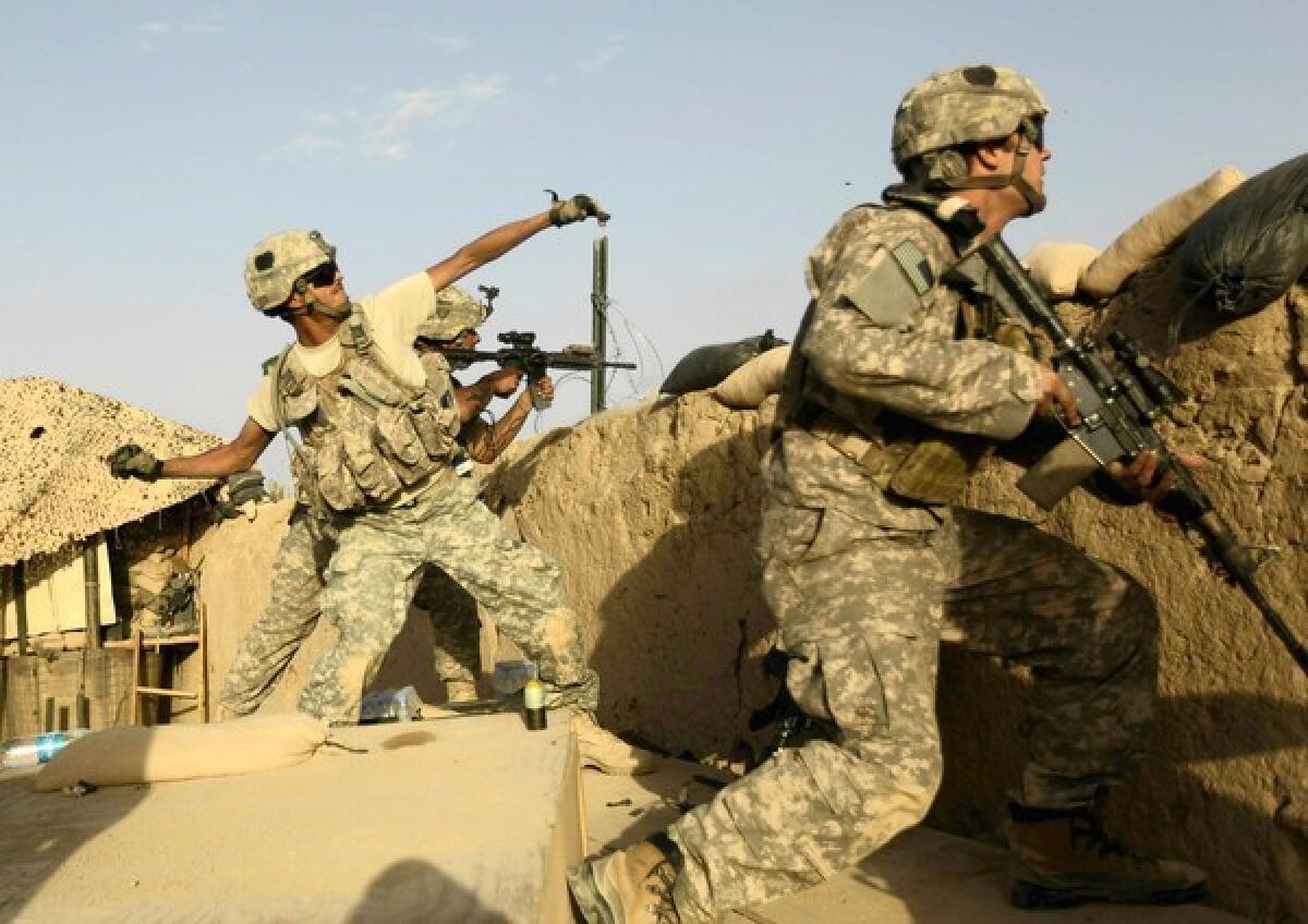 A U.S. Army soldier lobs a grenade in Afghanistan.