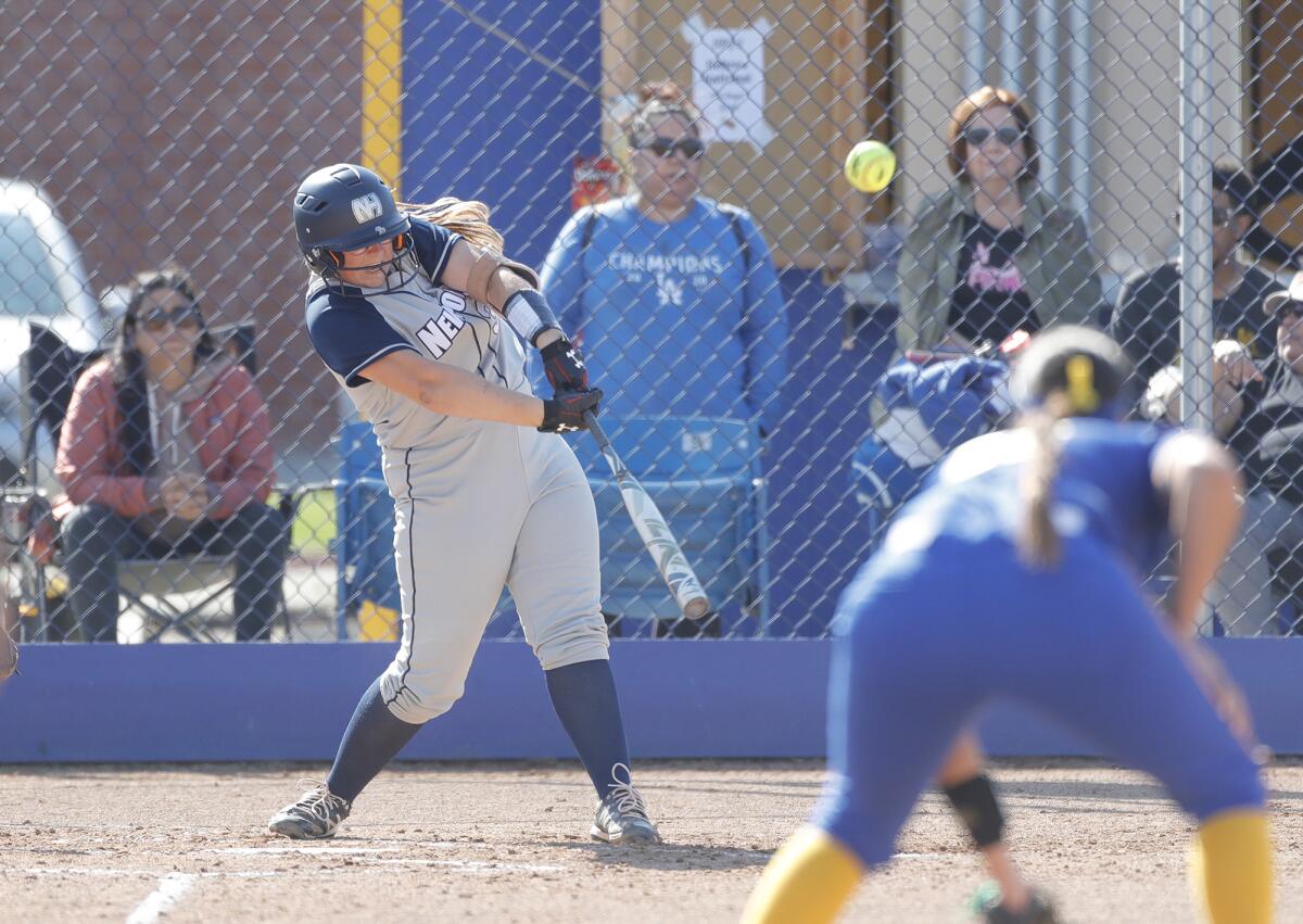 Newport Harbor's Kori Villeneuve hits a double during a Wave League softball game against Fountain Valley on Tuesday.