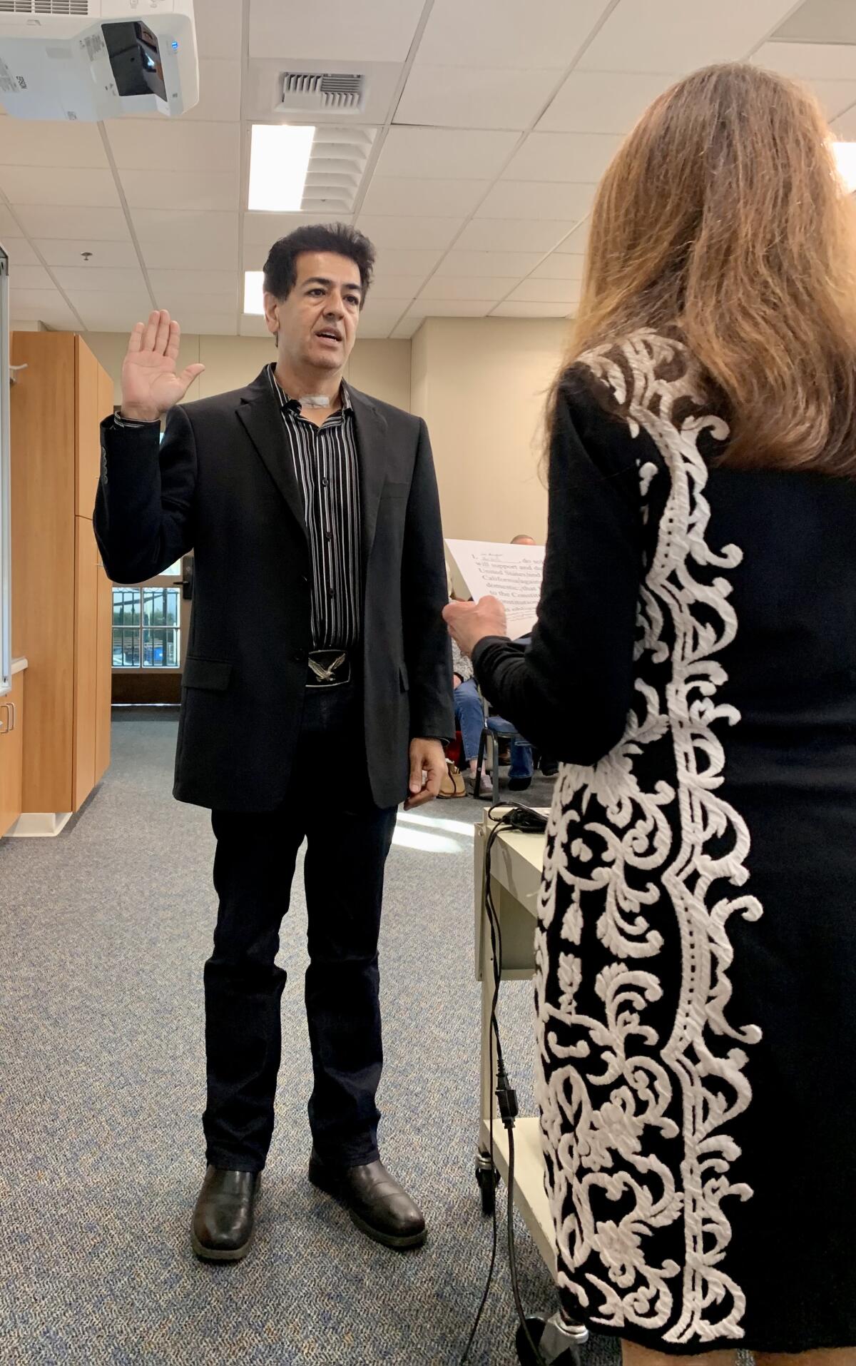 RSF School District board trustee Jee Manghani takes the oath of office.