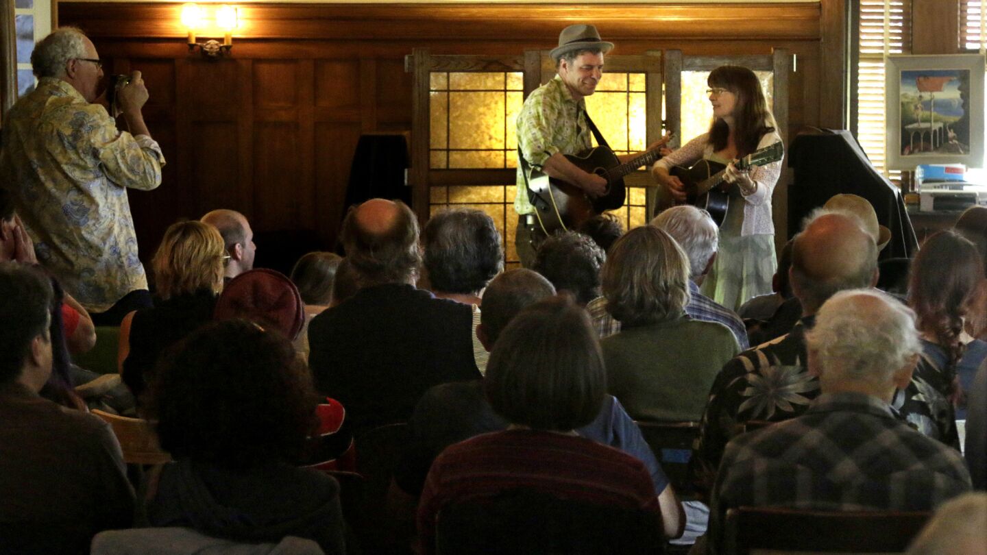 Musicians John Grimm and Beverly Smith perform before an audience in the living room at David Bunn's farmhouse in the Santa Paula area on May 24, 2015. Bunn, an artist and citrus farmer in Santa Paula has hosted a series of roots music concerts, the Deep End Sessions.