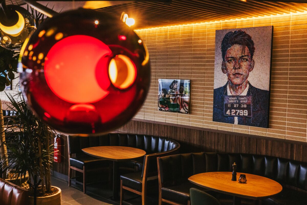 The interior of Joey Newport Beach with materials like light brick, warm wood, stone and leather.