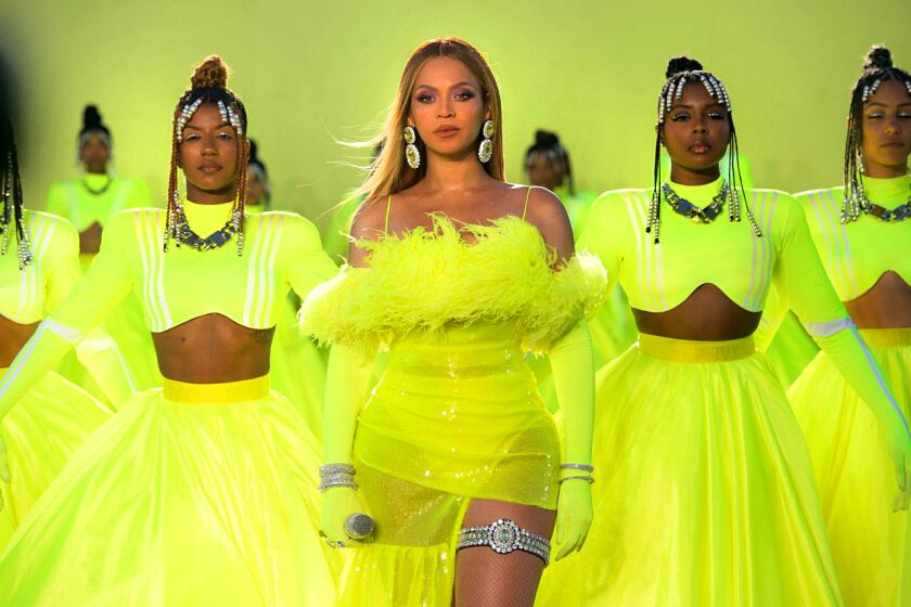 A row of women wearing lime green dresses against a lime green background