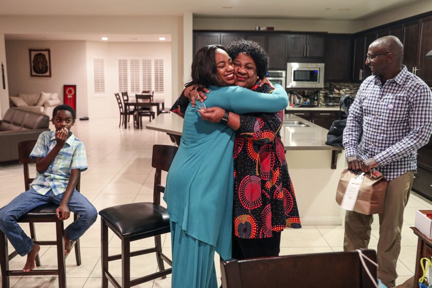 Dr. Akilah Weber hugs her mother, CA Secretary of State Shirley Weber, after hearing positive election results 