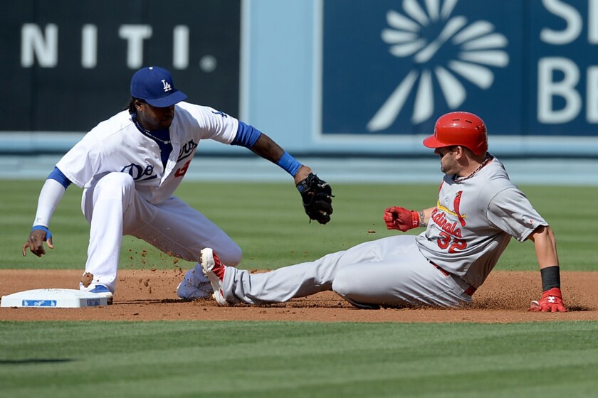 Cardinals first baseman Matt Adams beats the throw to Hanley Ramirez at second on a double in the first inning of the Dodgers' 9-1 win Saturday over St. Louis at Dodger Stadium.