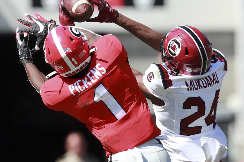 South Carolina defensive back Israel Mukuamu intercepts a pass intended for Georgia wide receiver George Pickens during the second quarter of an NCAA college football game, Saturday, Oct., 12, 2019, in Athens, Ga. Mukuamu returned the ball for a touchdown. (Curtis Compton/Atlanta Journal-Constitution via AP)