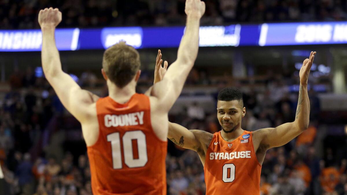 Syracuse seniors Trevor Cooney (10) and Michael Gbinije (0) are playing in their second Final Four, this time with the formidable task of playing North Carolina on Saturday.