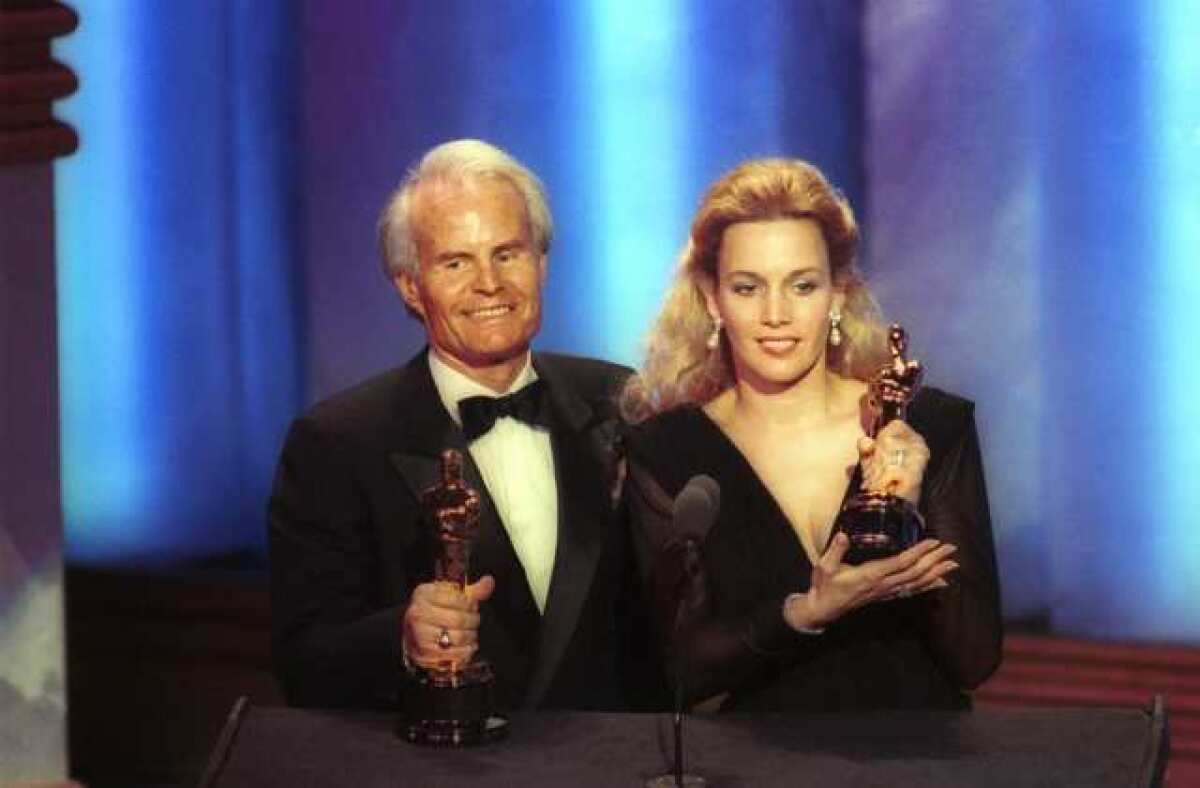 Richard D. Zanuck, left, with Lili Fini Zanuck, accepting best picture Oscars for "Driving Miss Daisy" in 1990 at the Academy Awards in Los Angeles.
