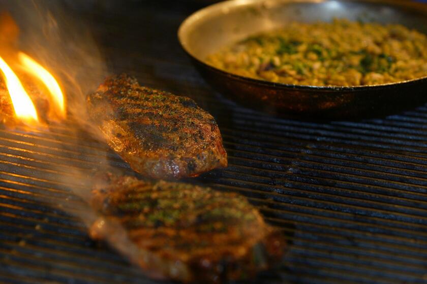 Grilled prime rib steaks with cannellini beans and red wine sauce. Read the recipe