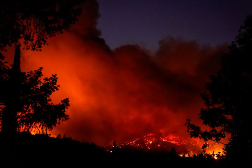 The night sky glows orange from the Glass Fire, as firefighters work to contain the wildfire in Napa County on Sunday.
