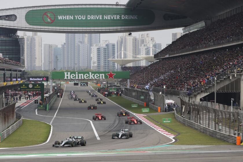 FILE - Drivers prepare for the start of the Chinese Formula One Grand Prix at the Shanghai International Circuit, Sunday, April 14, 2019, in Shanghai, China. Formula One confirmed Friday, Dec. 2, 2022 that the Chinese Grand Prix will not take place in 2023, making it the fourth year in a row the race has been canceled because of the coronavirus pandemic. (AP Photo/Ng Han Guan, File)