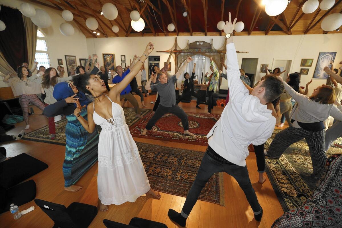 Matthew Cohen, center, a Qigong teacher, leads a group in Chinese energy cultivation practices at Full Circle, described as a free-form spiritual community in Venice.