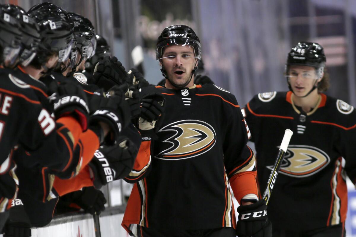 Sam Carrick is congratulated by teammates after a goal.