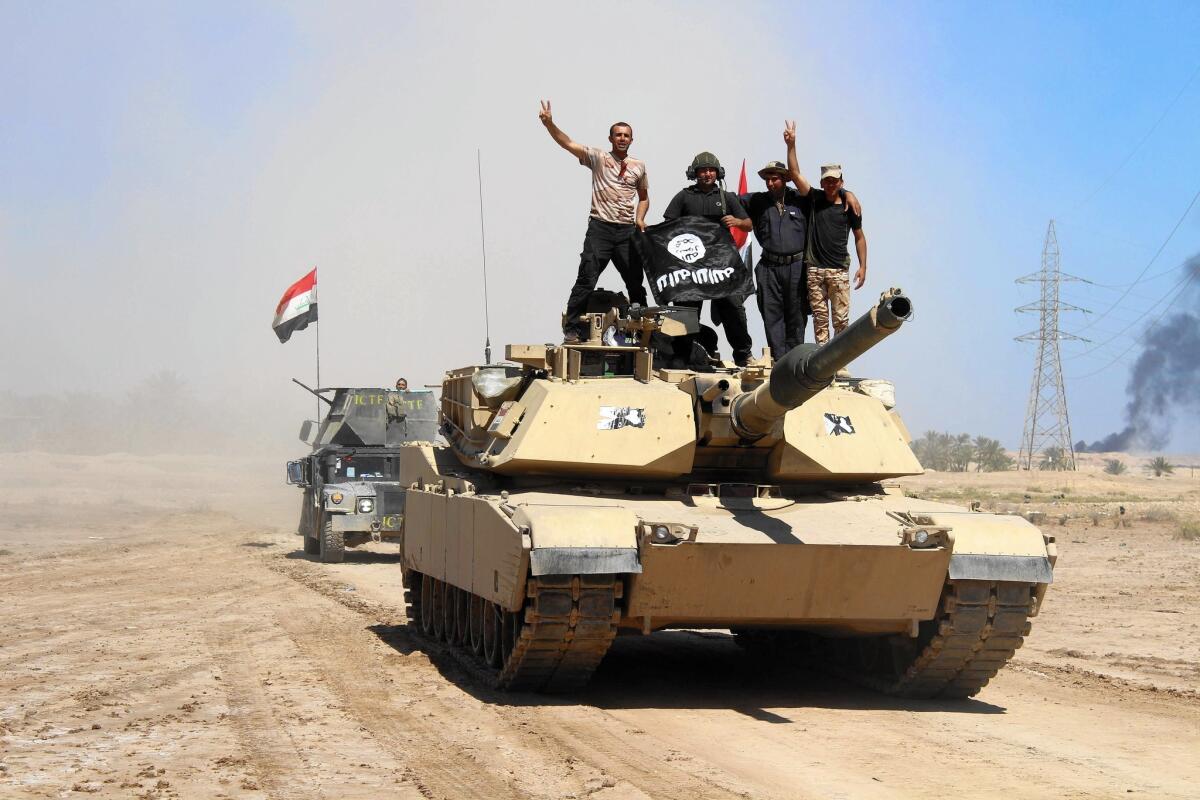 Iraqi government forces celebrate after retaking an area near Hit from Islamic State militants in April.