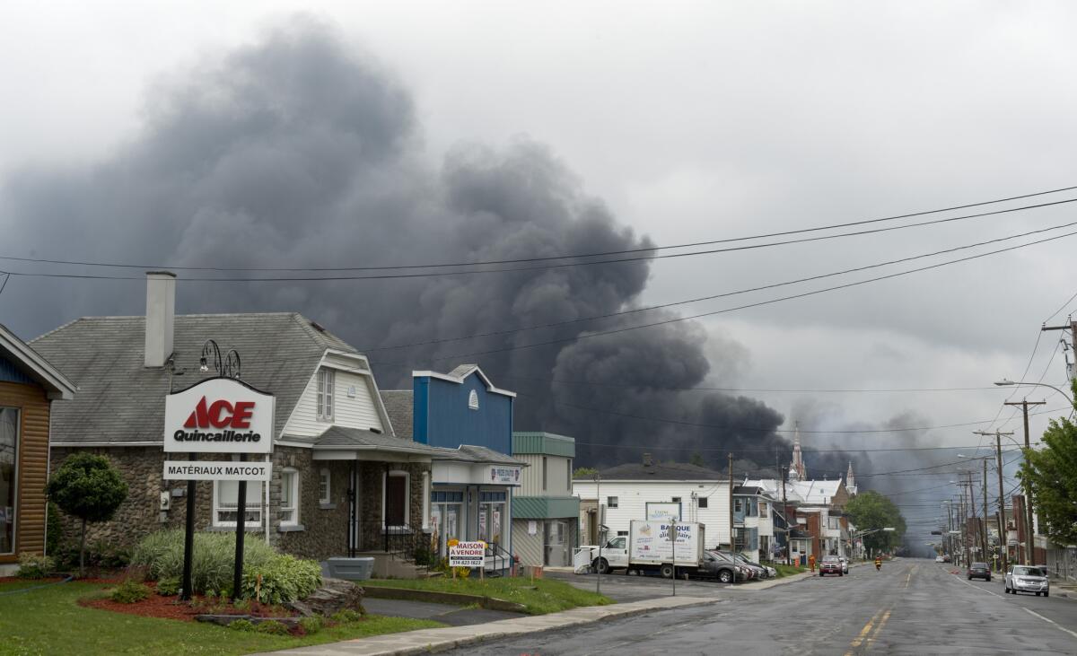 Smoke rises from railway cars that were carrying crude oil after derailing in downtown Lac Megantic, Quebec, Canada on Saturday.