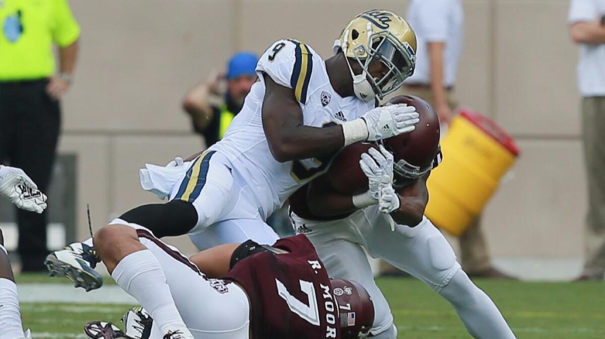 UCLA running back Soso Jamabo is tackled during the Bruins' overtime loss to Texas A&M at Kyle Field in College Station, Texas, on Sept. 3.