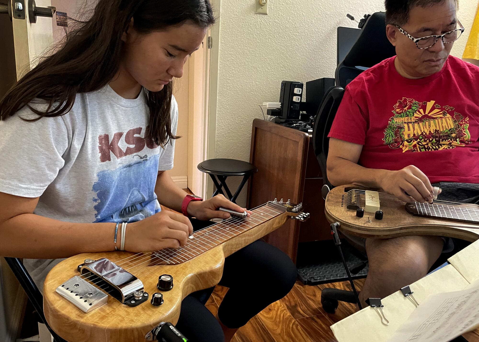 music A student learns Hawaiian steel guitar.