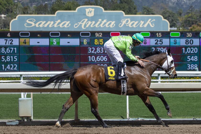 Discrete Stevie B ridden by Aaron Gryder wins the first race as racing resumes at Santa Anita Park in Arcadia, Calif.