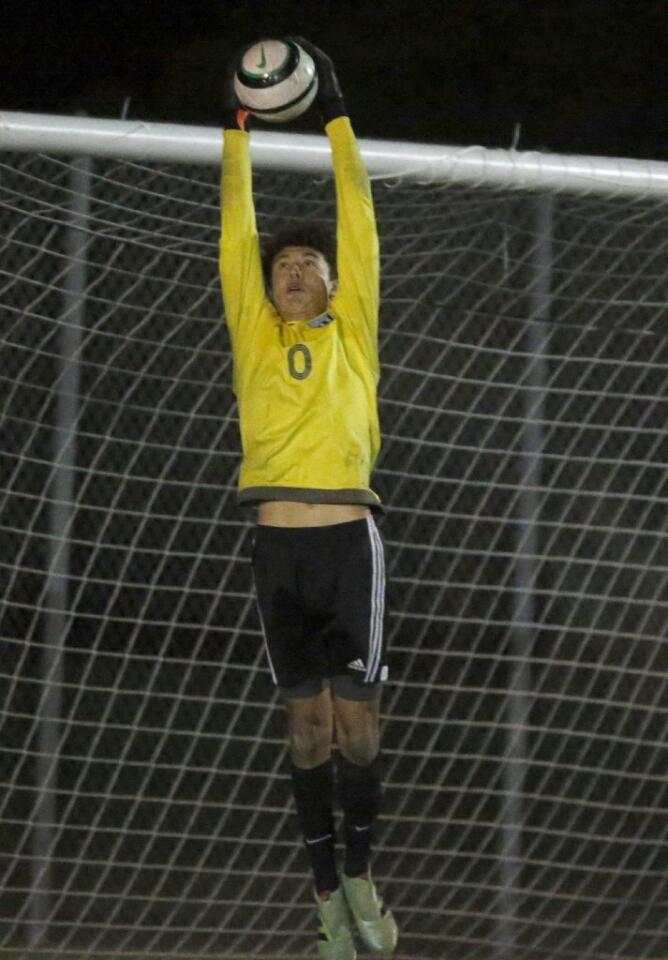 Edison goalkeeper Mitchel Wilson goes high for a save against Newport Harbor.