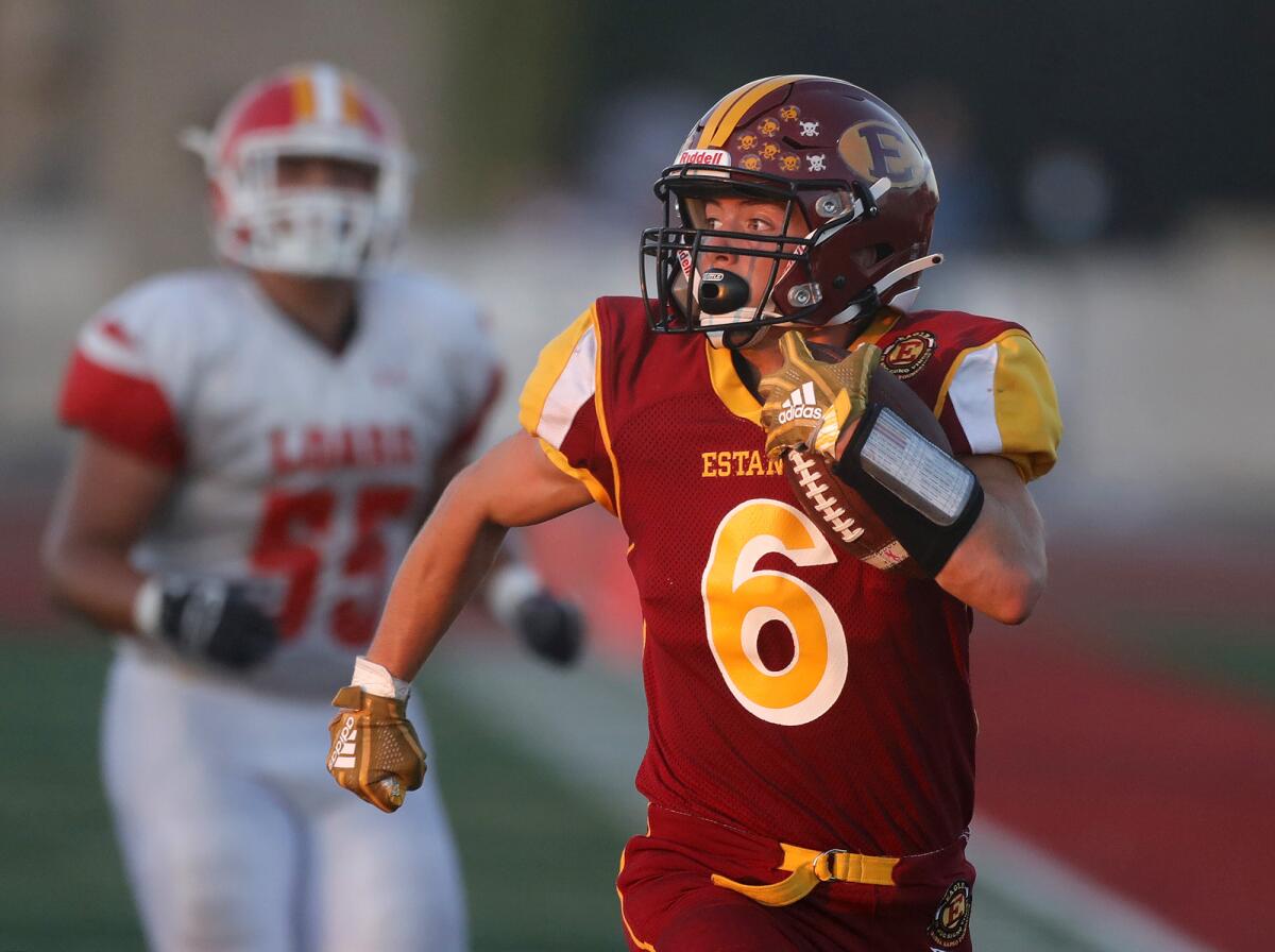 Estancia's Noah Aires runs down the sideline untouched for a score in first half against Loara on Friday.