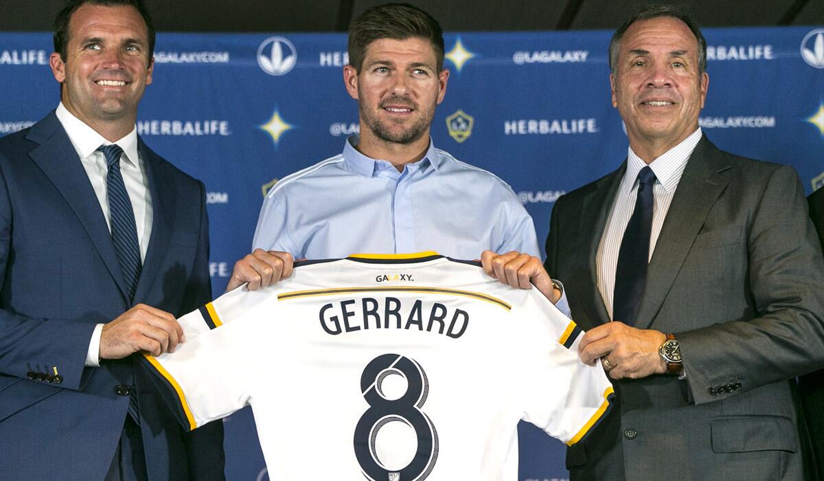 Los Angeles Galaxy President Chris Klein, left, and LA Galaxy Head Coach and General Manager Bruce Arena, right, introduce their new midfielder, Steven Gerrard, during a news conference at StubHub Center on Tuesday.