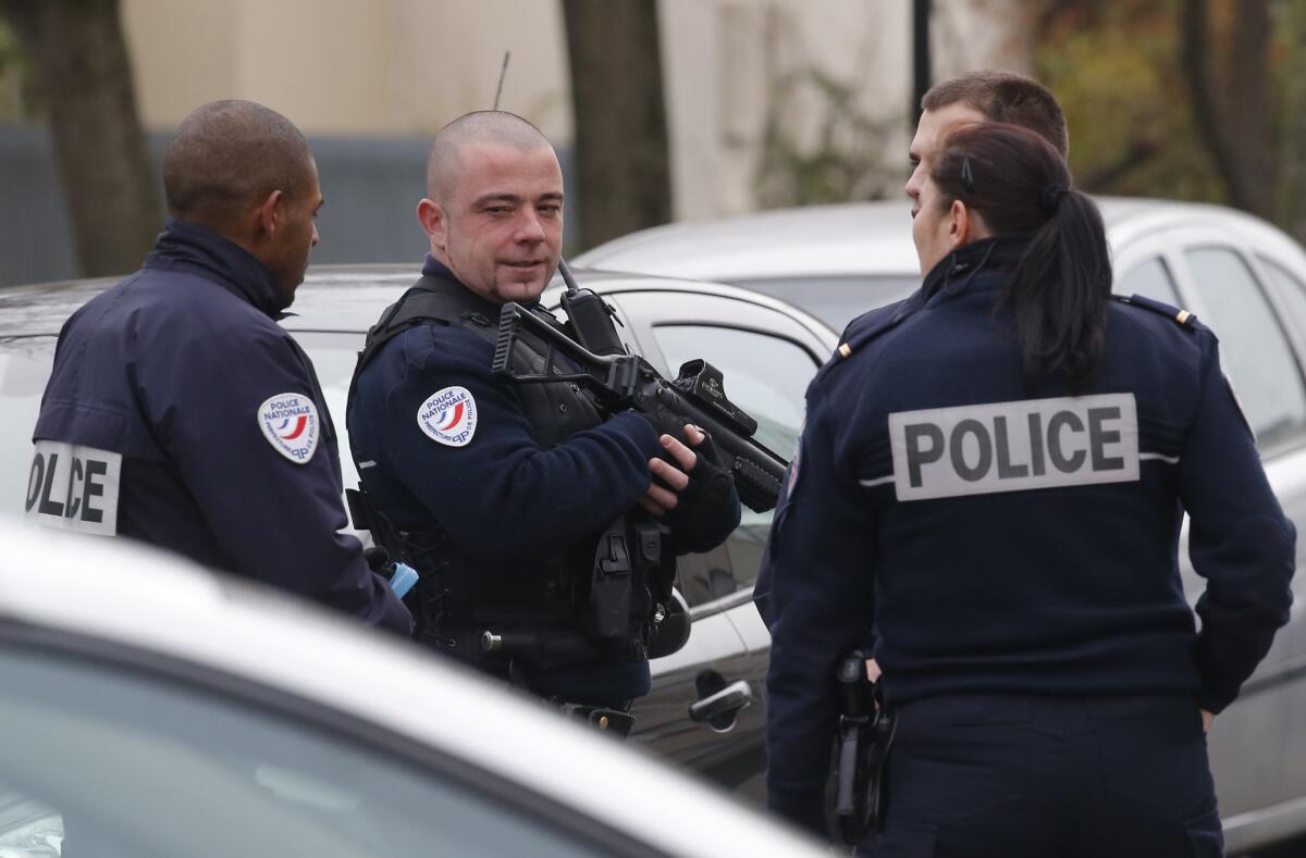 Police officers patrol near a preschool in Aubervilliers, France, on Monday after a teacher reported that being attacked by a masked assailant with a box cutter or knife yelling about Islamic State.