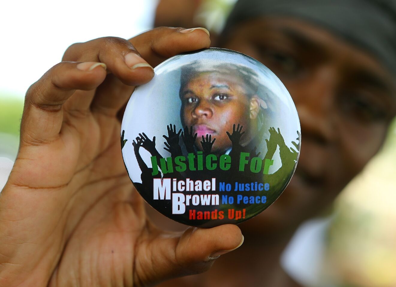 Nikki Jones of Spanish Lake, Mo., displays a button in support of Michael Brown.