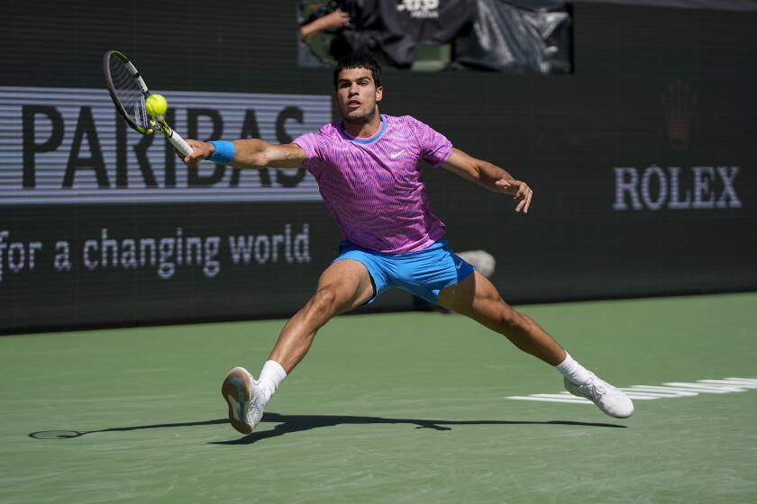 Carlos Alcaraz, of Spain, hits a return to Fabian Marozsan, of Hungary, during their match at the BNP Paribas Open tennis tournament Tuesday, March 12, 2024, in Indian Wells, Calif. (AP Photo/Mark J. Terrill)