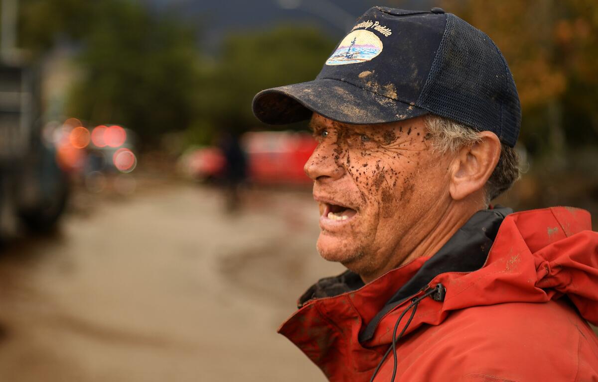 A muddy Mark Olson stands along Olive Mill Road in Montecito after trying to save his house during the storm. Olson had minor damage to his house.