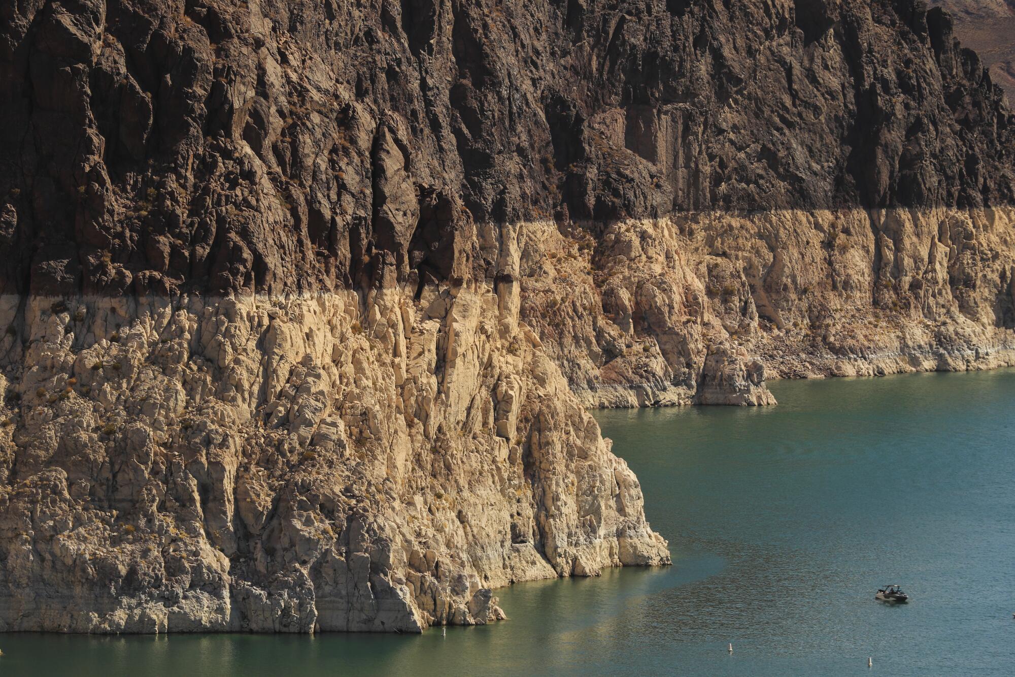 A boater gets an up-close view of the "bathtub ring" on Lake Mead 